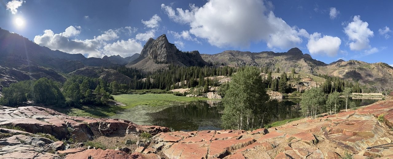 A Utah mountain trail climbing toward a valley view